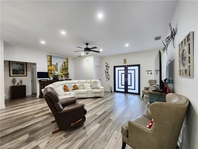 a living room with furniture and a wooden floor