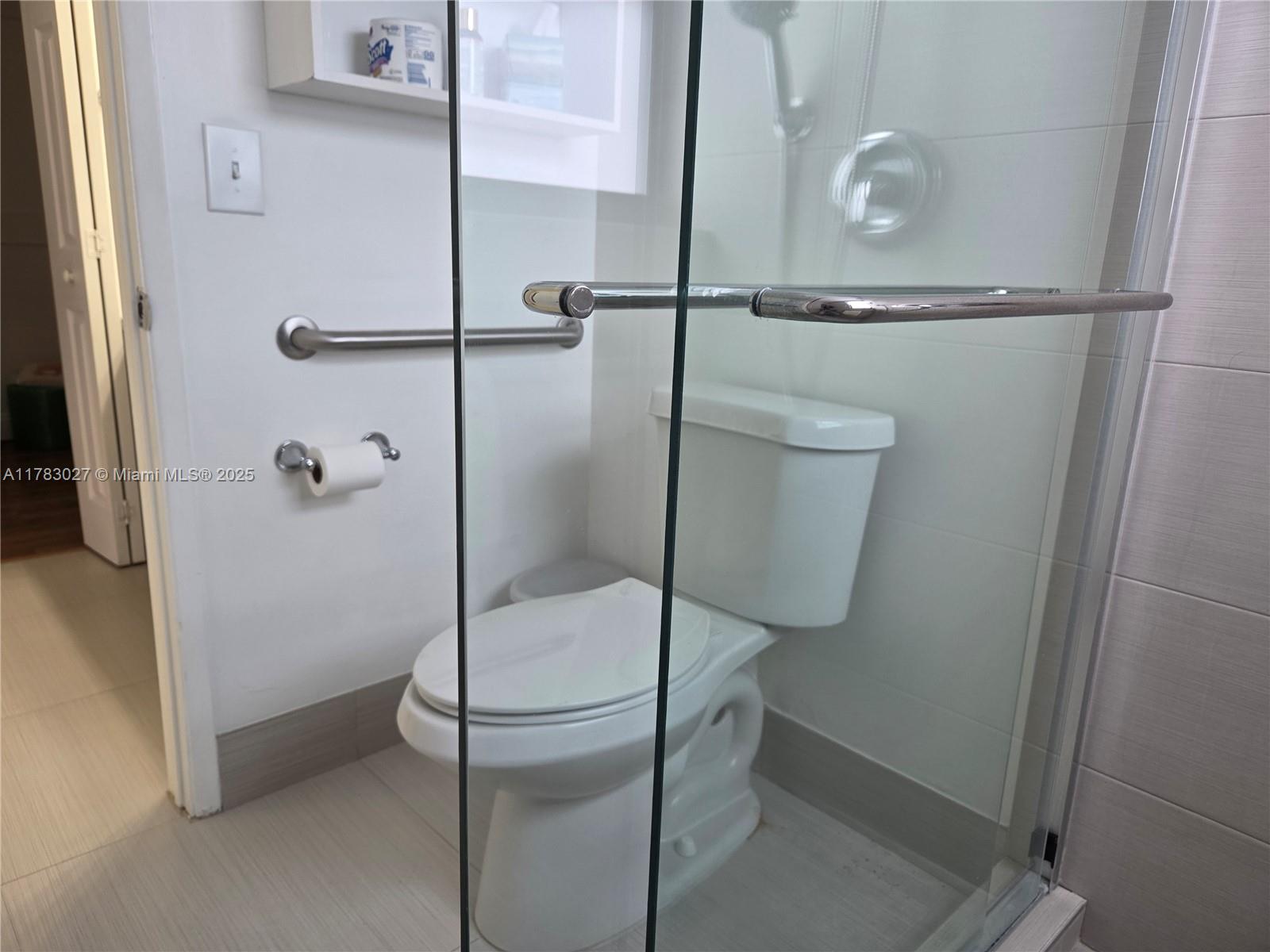 8850 Southwest 123rd Court, Unit H302 Miami, FL 33186 - Photo 13 of 28 a bathroom with a glass shower door