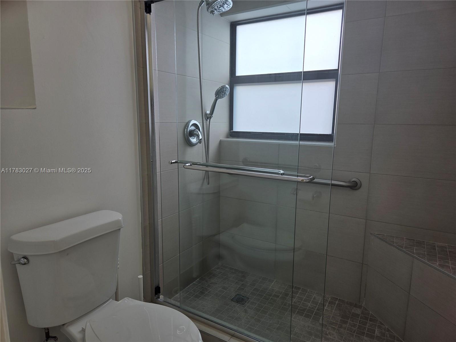 8850 Southwest 123rd Court, Unit H302 Miami, FL 33186 - Photo 14 of 28 a bathroom with a toilet and a shower