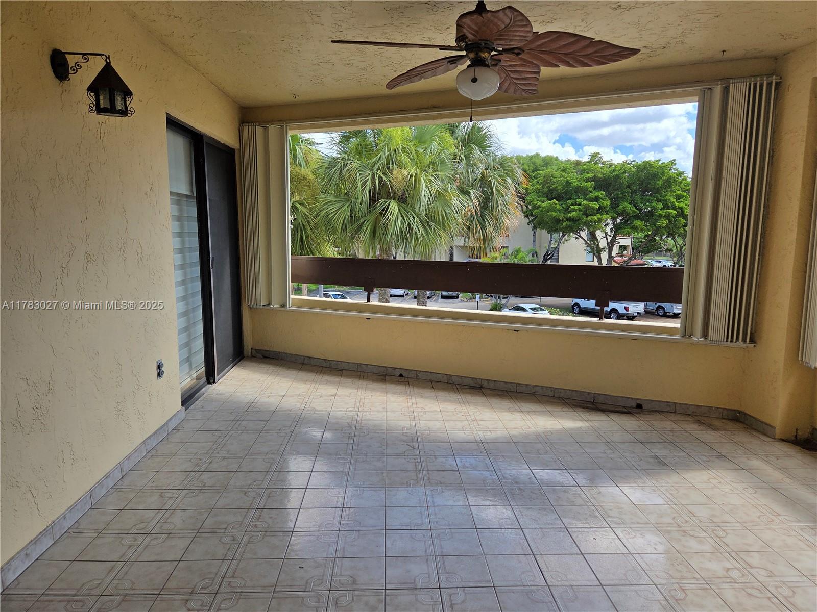 8850 Southwest 123rd Court, Unit H302 Miami, FL 33186 - Photo 21 of 28 a view of a floor to ceiling window and a ceiling fan