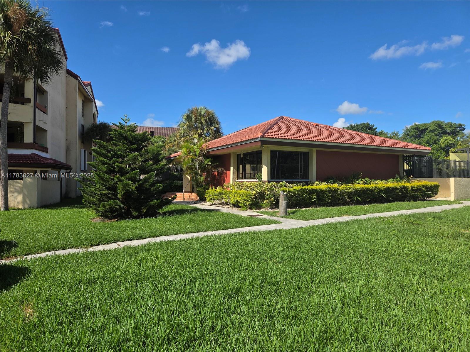 8850 Southwest 123rd Court, Unit H302 Miami, FL 33186 - Photo 25 of 28 a front view of a house with a yard