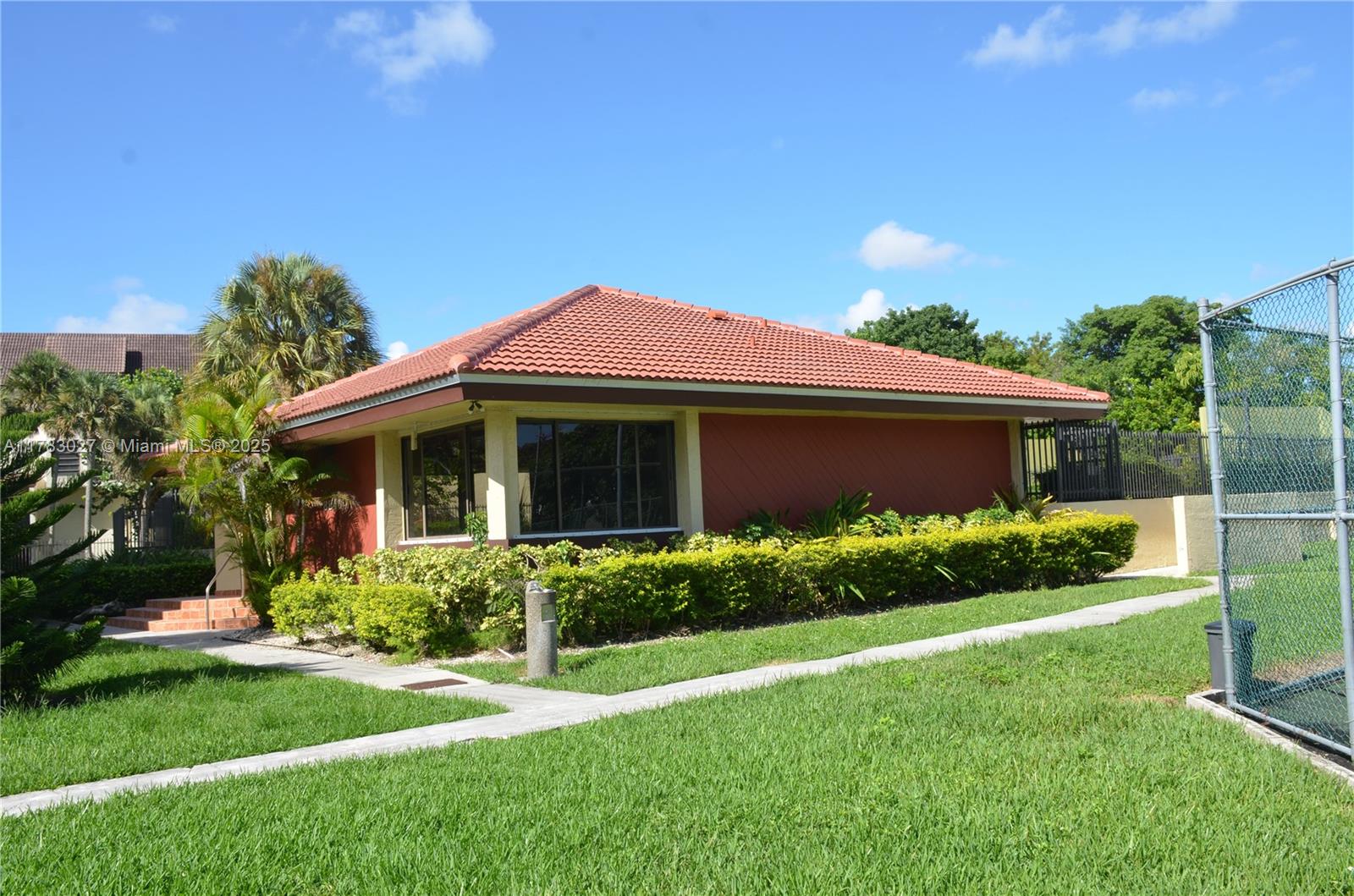 8850 Southwest 123rd Court, Unit H302 Miami, FL 33186 - Photo 26 of 28 a front view of a house with a yard