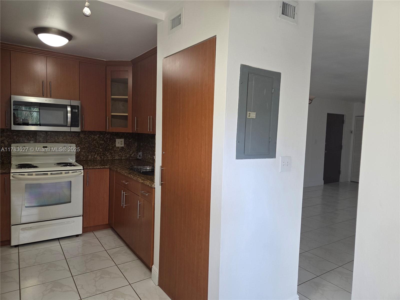 8850 Southwest 123rd Court, Unit H302 Miami, FL 33186 - Photo 6 of 28 a kitchen with a refrigerator stove and microwave