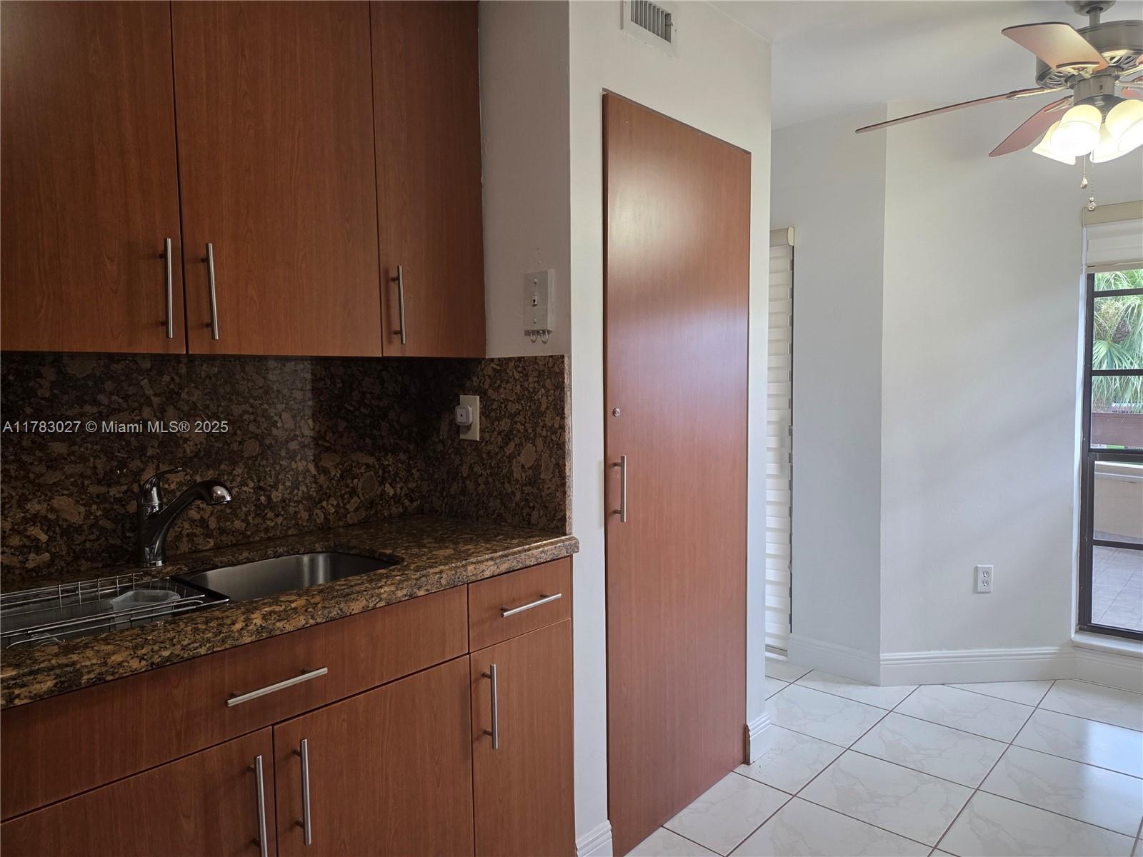 8850 Southwest 123rd Court, Unit H302 Miami, FL 33186 - Photo 7 of 28 a kitchen with a sink and cabinets