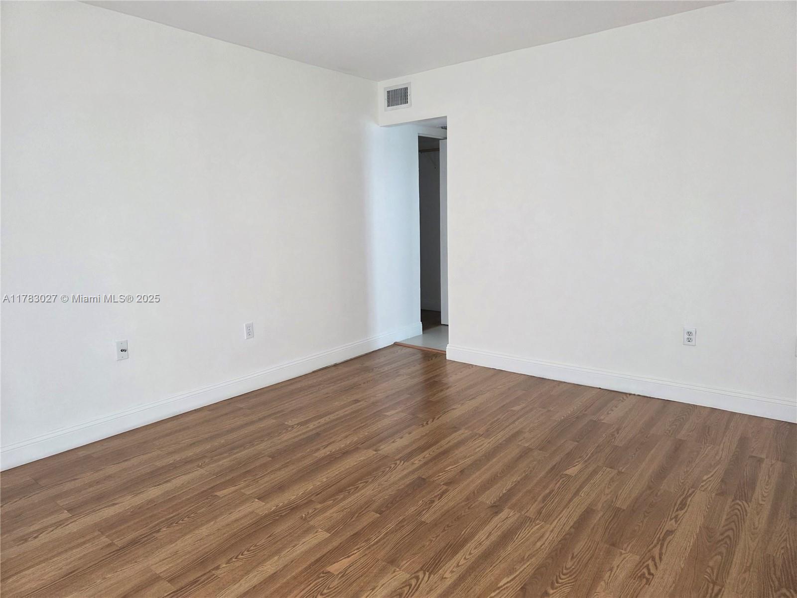 8850 Southwest 123rd Court, Unit H302 Miami, FL 33186 - Photo 10 of 28 a view of an empty room with wooden floor