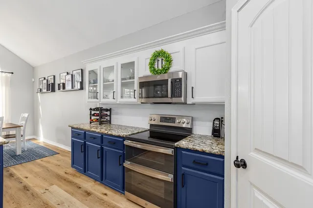 a kitchen with stainless steel appliances granite countertop a stove and a sink