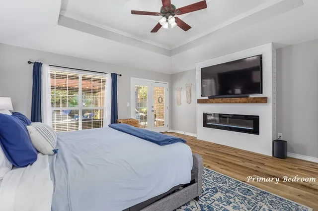 a spacious bedroom with a bed and a flat screen tv