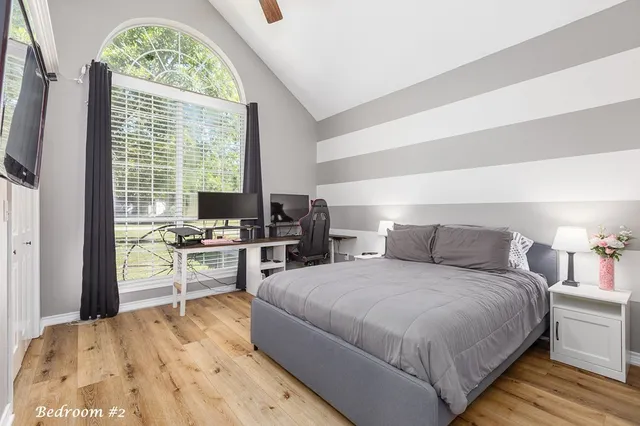 a bedroom with a bed and a desk