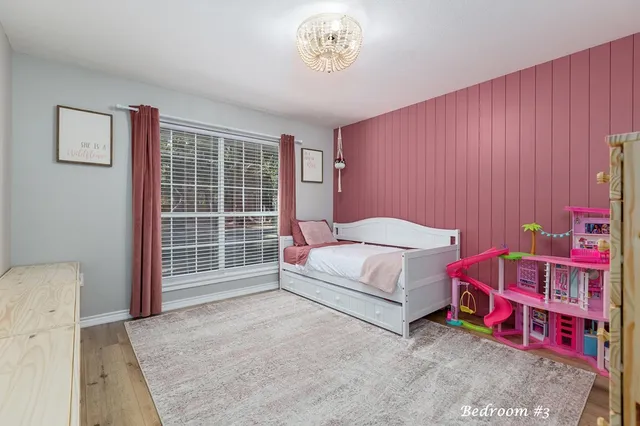 a spacious bedroom with a bed and a window