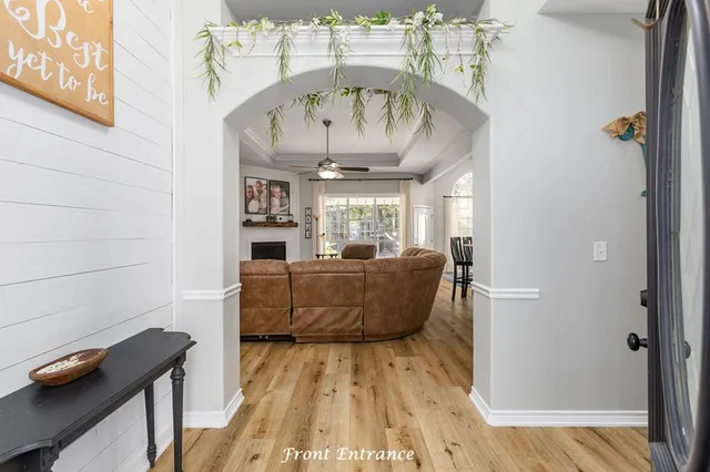 a living room with furniture and a wooden floor