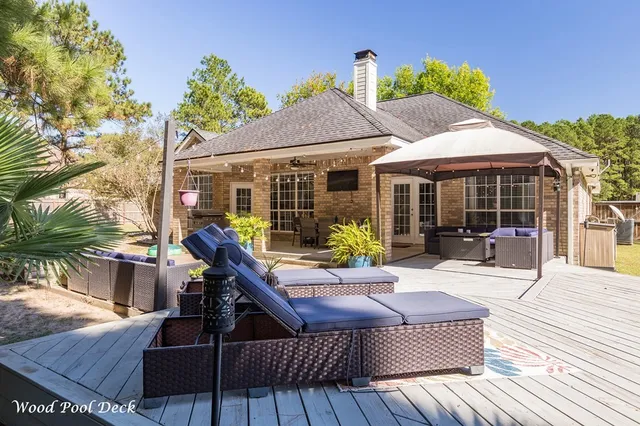 a view of a dinning table and chairs in patio of the house