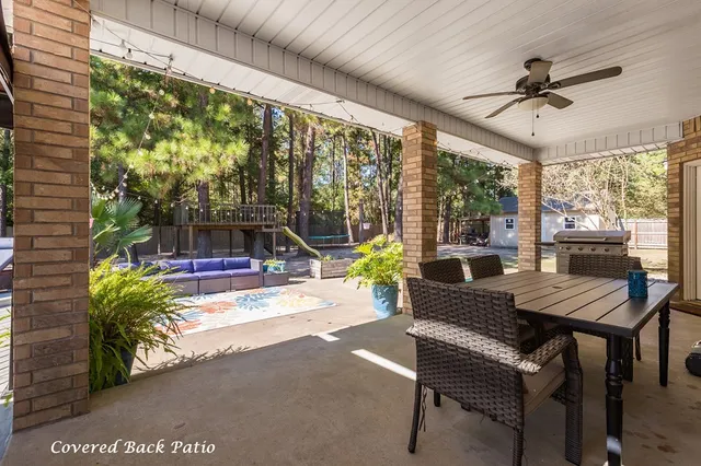 a view of a patio with a table chairs and a potted plant