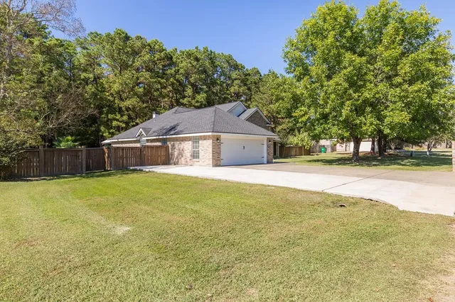a house with huge green field in front of it