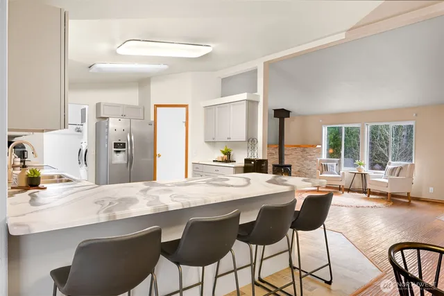 a view of a dining table chairs and chandelier