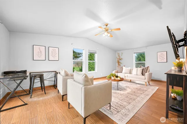 a living room with furniture and wooden floor