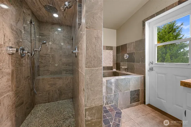 a bathroom with a granite countertop shower