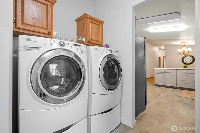 a view of a storage and utility room with washer and dryer