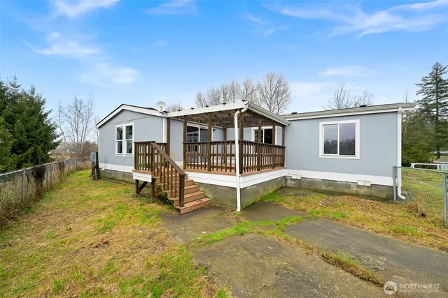 a view of a house with pool and sitting area