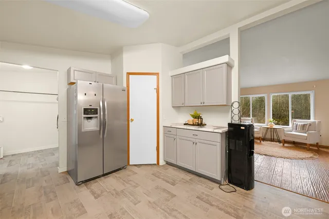 a kitchen with granite countertop a refrigerator and a stove top oven