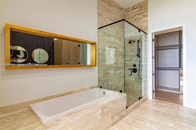 a bathroom with a tub and a shower