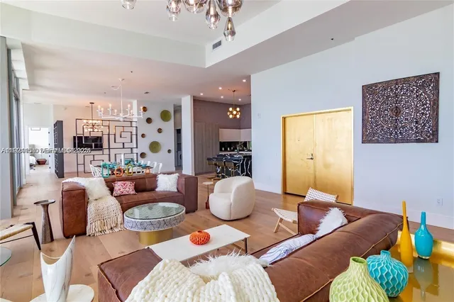 a living room with furniture and a chandelier