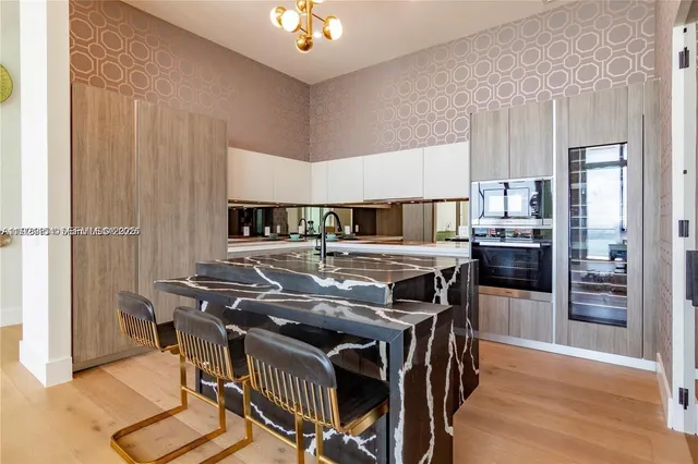 a kitchen with stainless steel appliances granite countertop a stove and a refrigerator