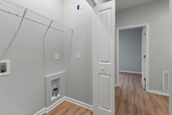 a view of a room with wooden floor