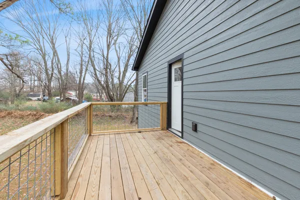 a view of backyard of house with wooden floor