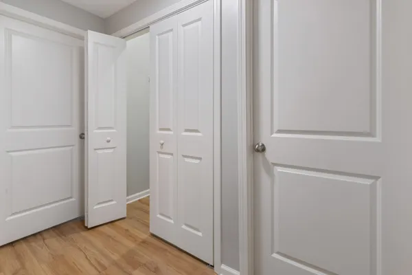 a view of a room with wooden floor