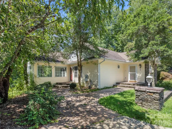 a front view of house with yard and green space
