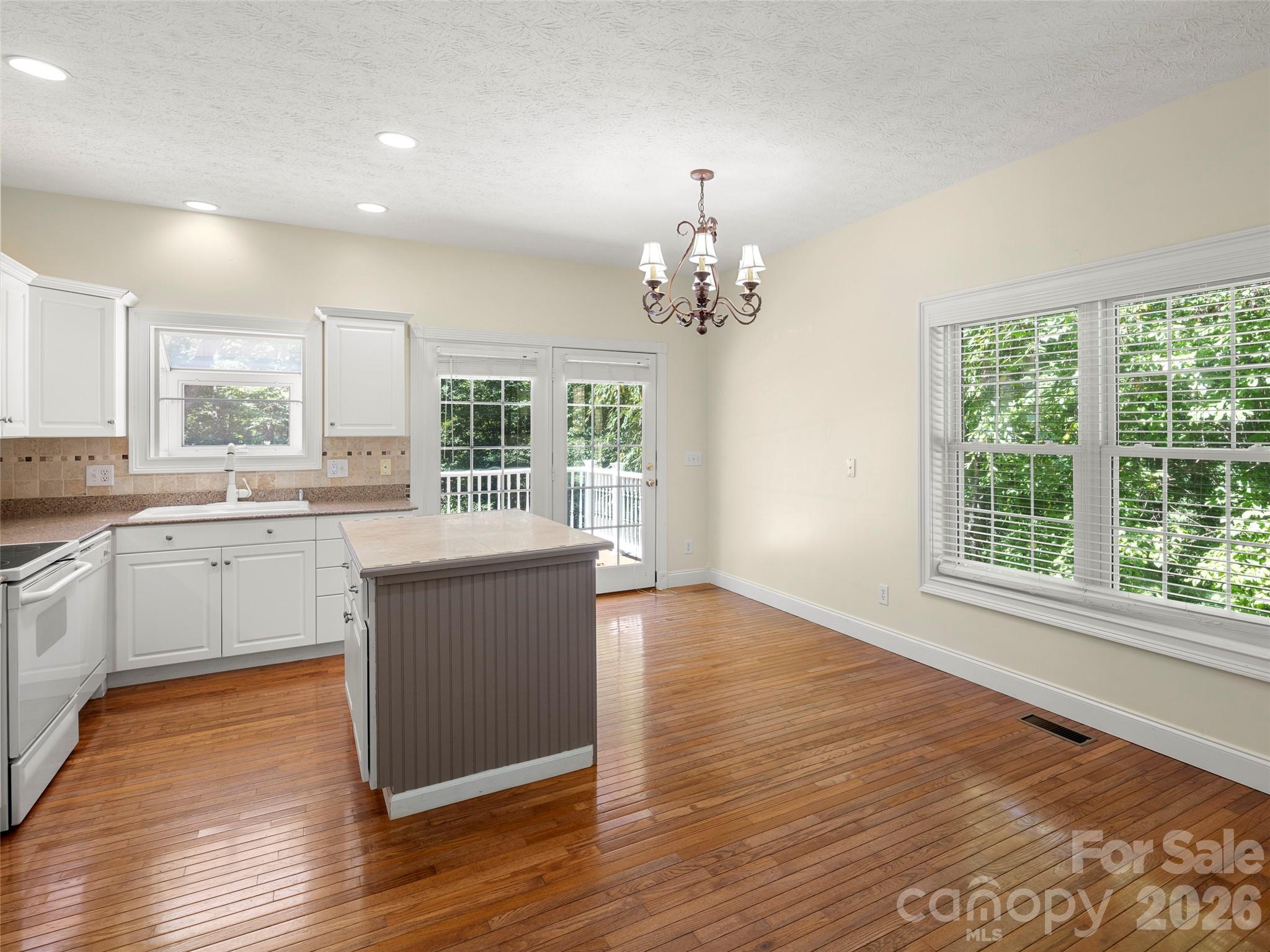 4901 Brevard Road Horse Shoe, NC 28742 - Photo 19 of 34 a view of a kitchen counter top a stove and wooden floor