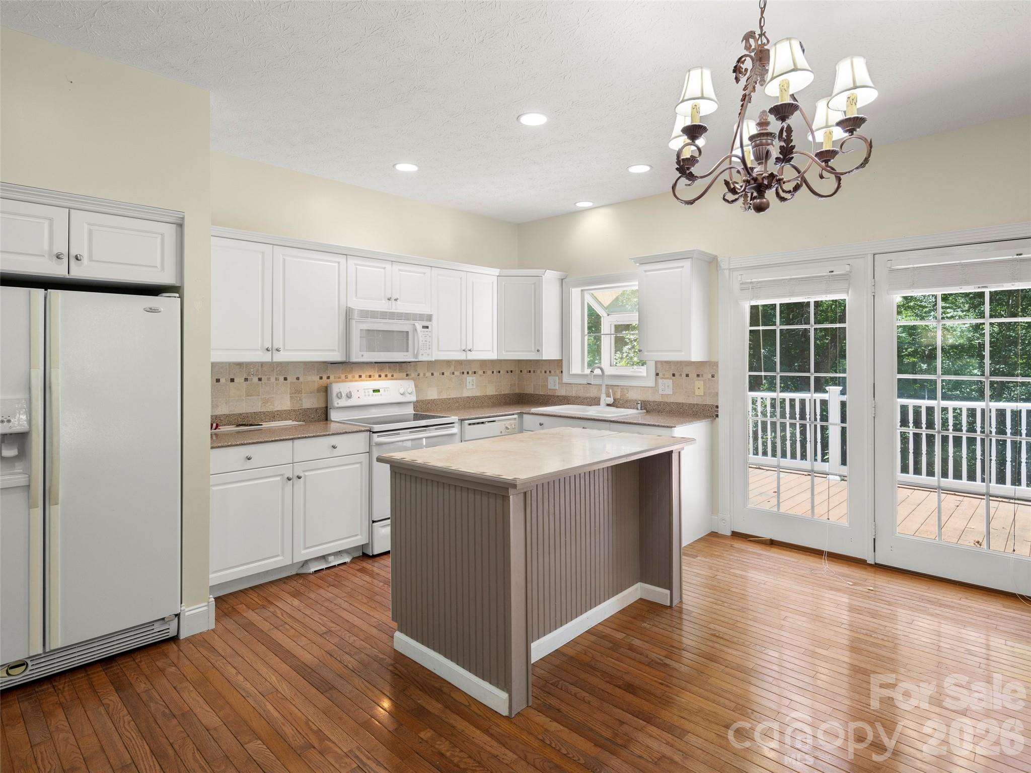 4901 Brevard Road Horse Shoe, NC 28742 - Photo 20 of 34 a kitchen with stainless steel appliances granite countertop a sink cabinets a refrigerator and a stove