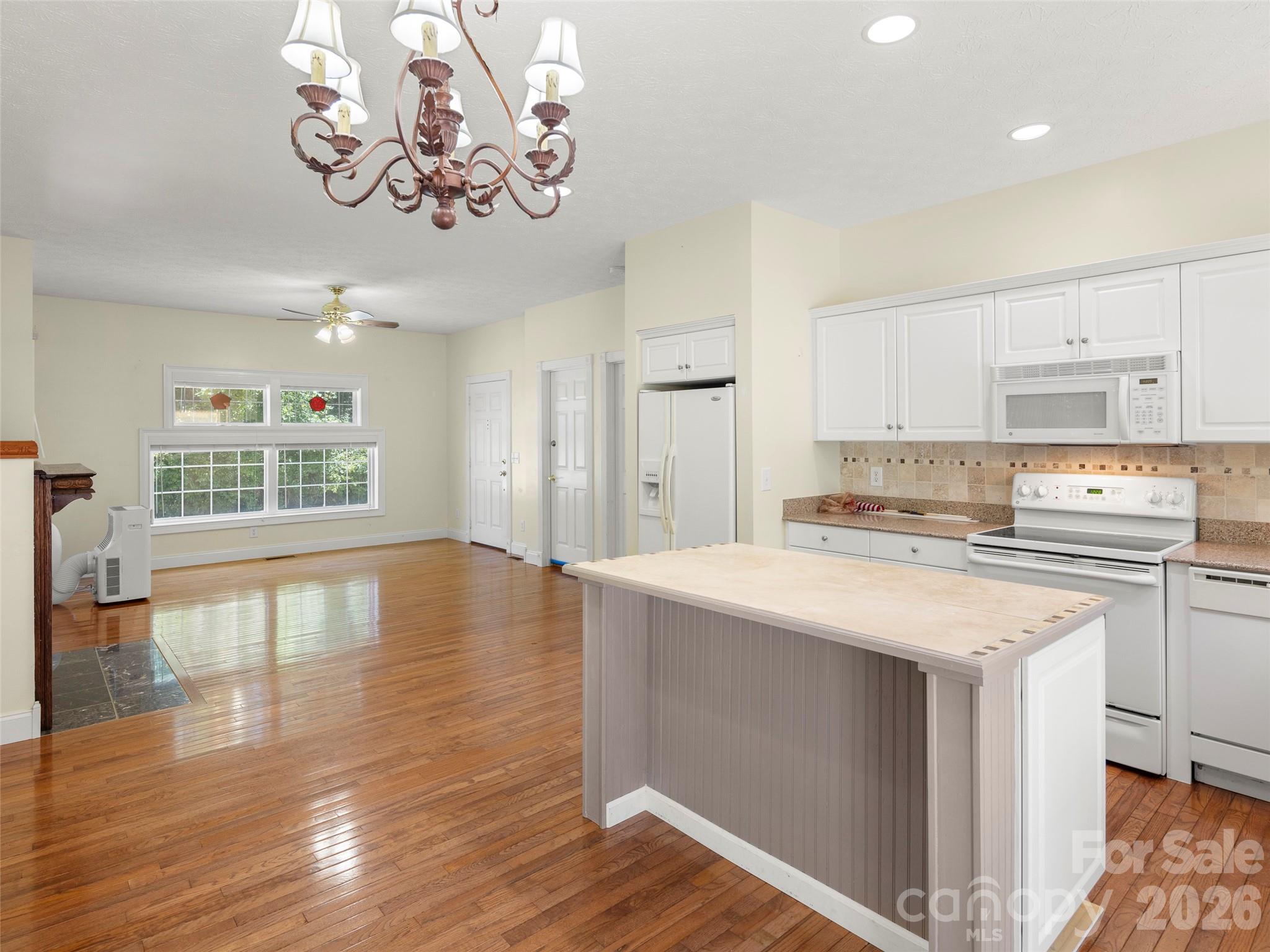 4901 Brevard Road Horse Shoe, NC 28742 - Photo 21 of 34 a kitchen with stainless steel appliances granite countertop a sink stove and wooden floor
