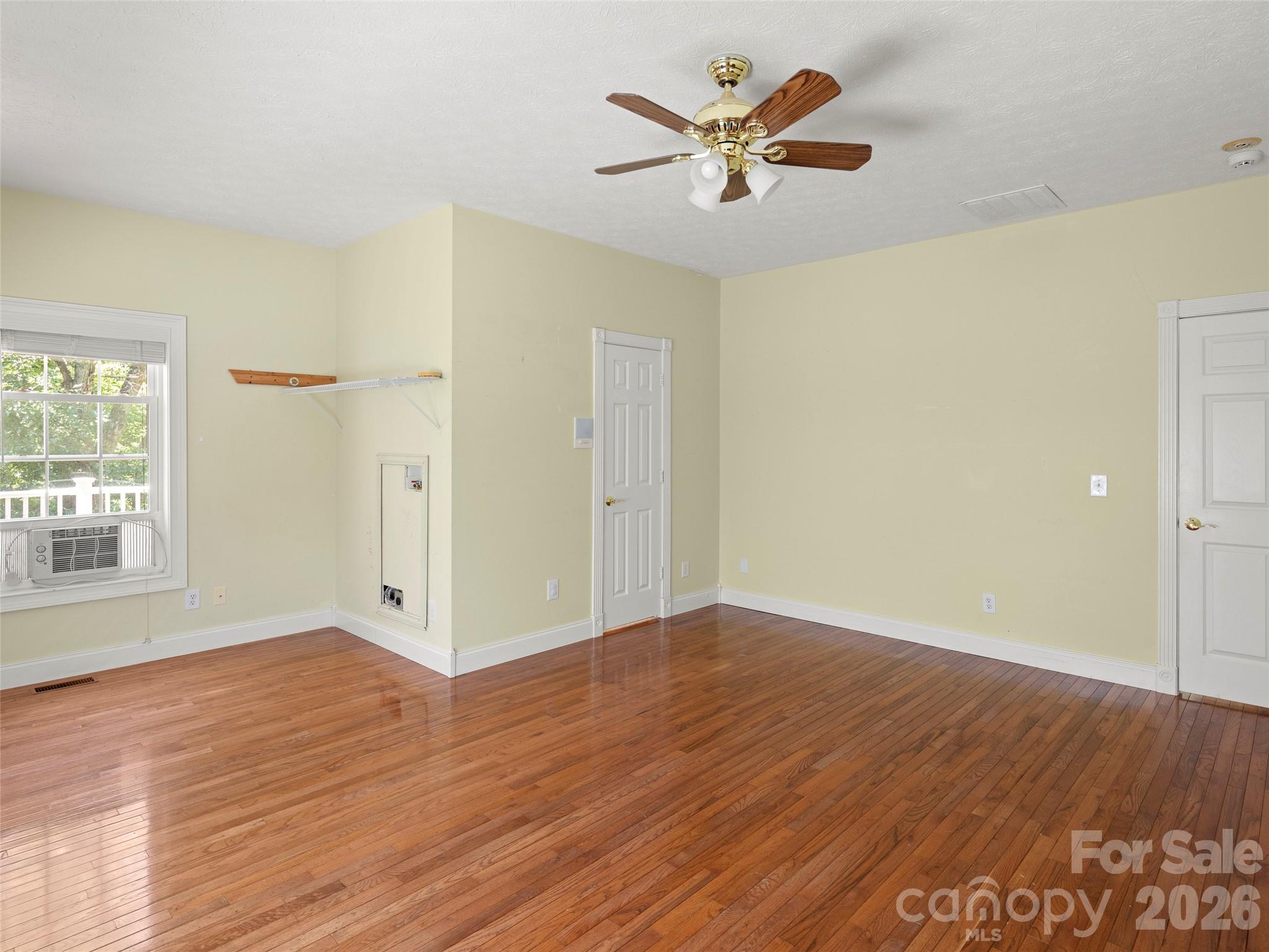 4901 Brevard Road Horse Shoe, NC 28742 - Photo 23 of 34 an empty room with wooden floor and windows