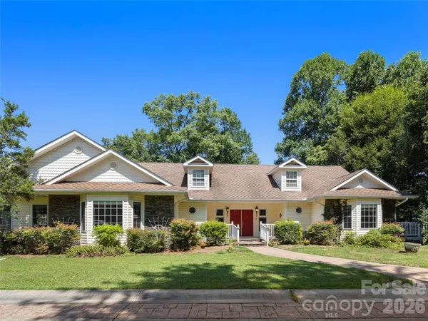 a front view of a house with a garden