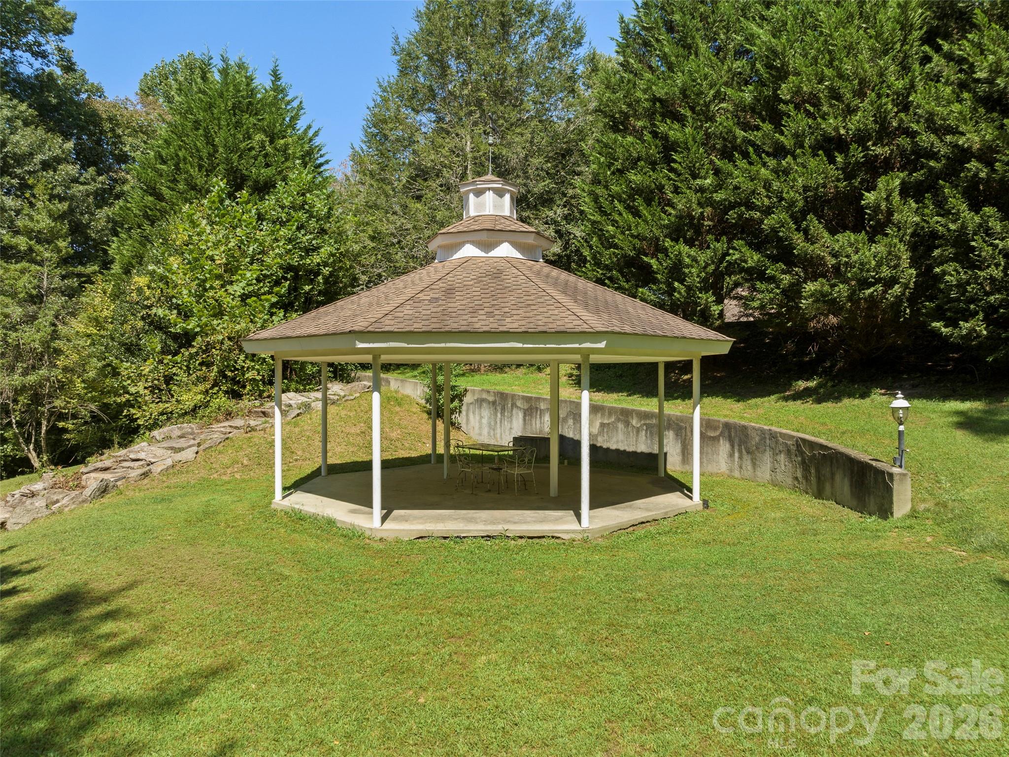 4901 Brevard Road Horse Shoe, NC 28742 - Photo 32 of 34 a backyard of a house with table and chairs