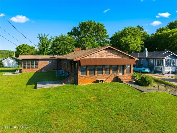 a front view of a house with yard porch and green space