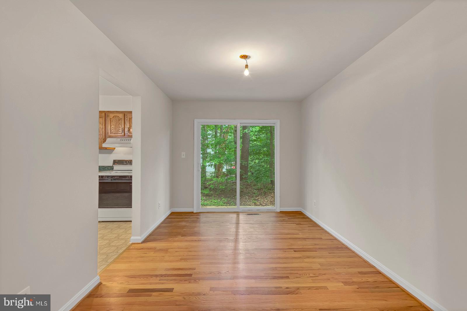 1010 Planters Wharf Road Lusby, MD 20657 - Photo 6 of 26 Dining room with hardwood floors and new slider