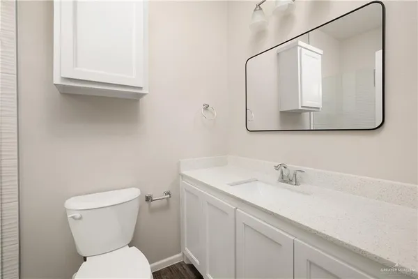 a white toilet sitting next to a bathroom sink