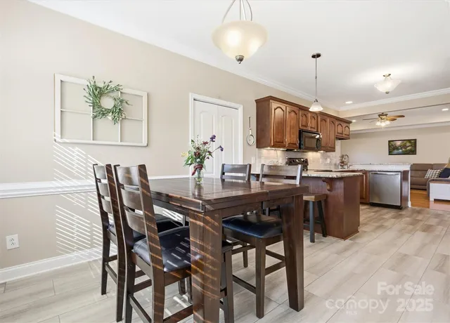 a kitchen with a table chairs and microwave