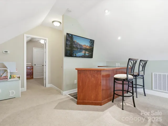 a view of a livingroom with furniture and a flat screen tv