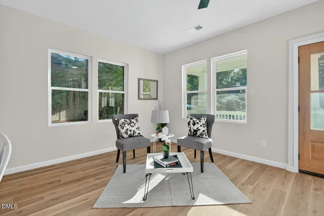 a dining room with wooden floor and a window