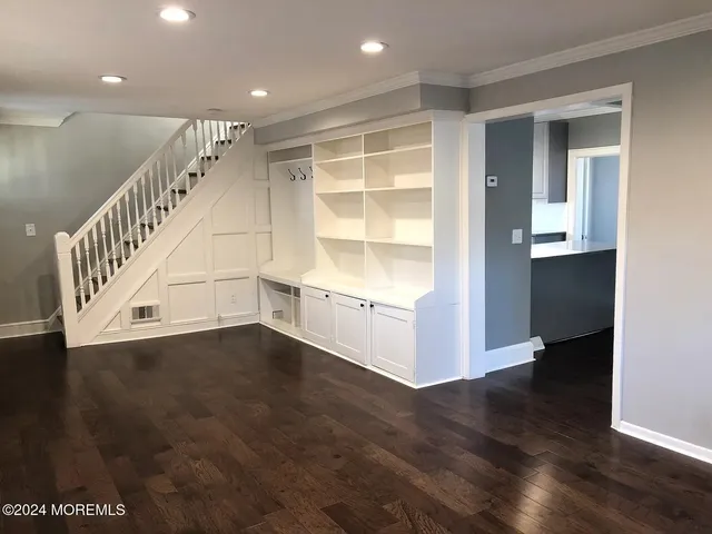a view of an entryway with wooden floor