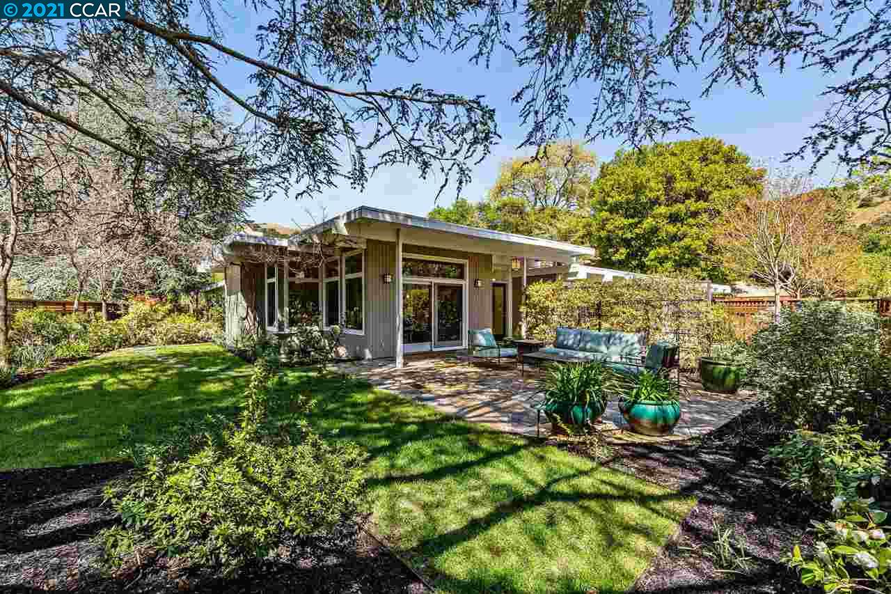 a front view of a house with a garden