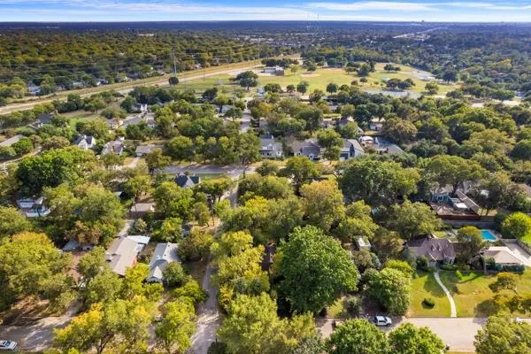 an aerial view of residential houses with outdoor space