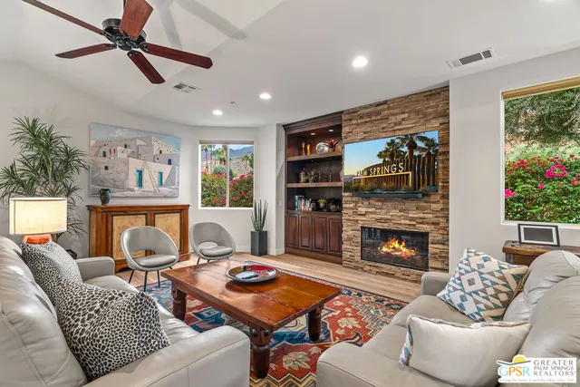 a living room with furniture and a fireplace