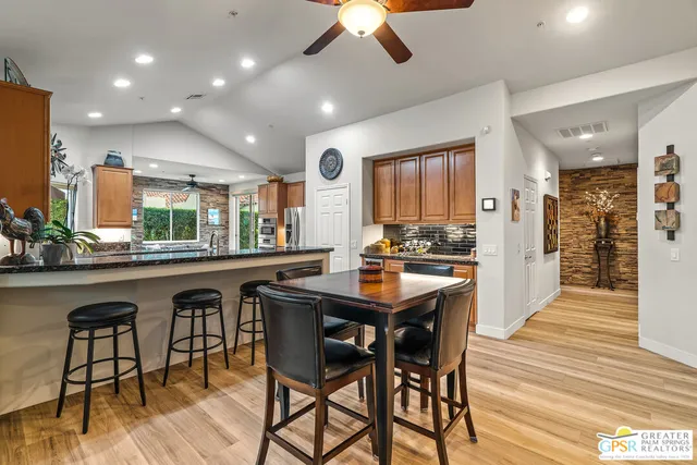 a kitchen with stainless steel appliances granite countertop a sink a counter space and cabinets