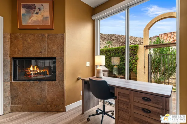 a bedroom with a bed and a lamp on dresser