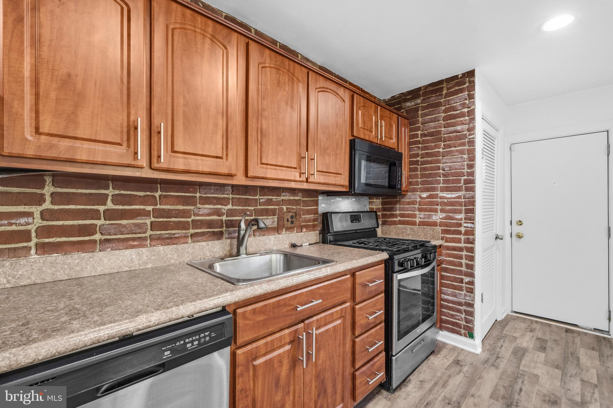 520 49th Street Northeast Washington, DC 20019 - Photo 11 of 38 a kitchen with stainless steel appliances granite countertop a sink stove and cabinets
