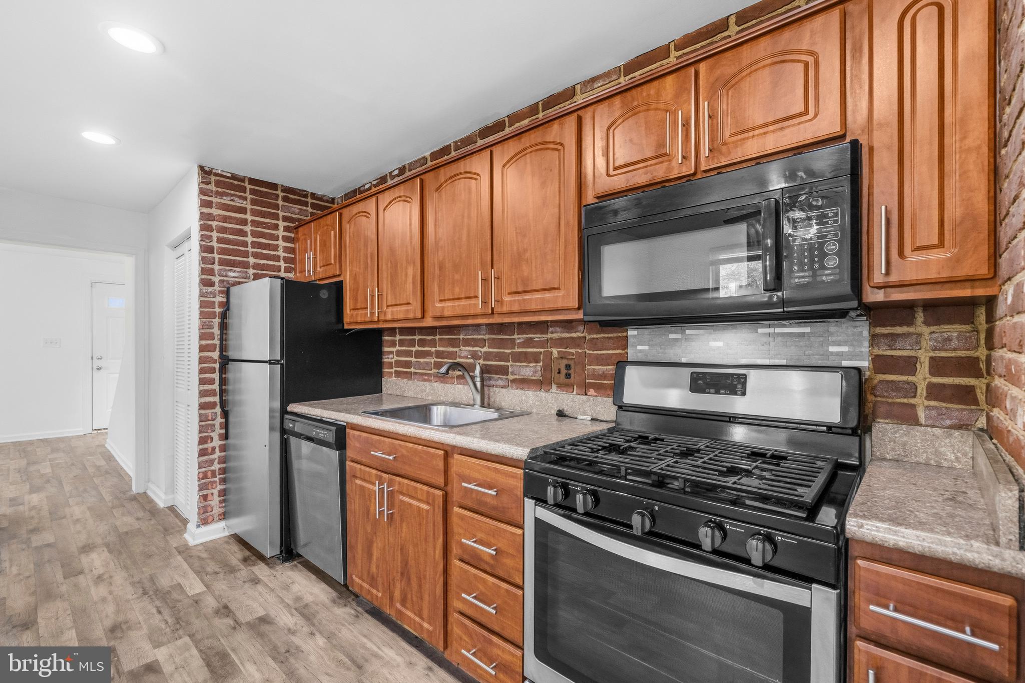 520 49th Street Northeast Washington, DC 20019 - Photo 12 of 38 a kitchen with stainless steel appliances granite countertop a stove microwave refrigerator and sink